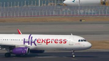 HONG KONG - NOVEMBER 10, 2019. Airbus A321, B-LEH of HK express taxiing at Chek Lap Kok Airport, side view. Plane on the taxiway or on the runway video