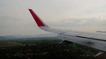 Flight arrival. Aircraft landing, view from the passenger seat. Aircraft porthole and wing video