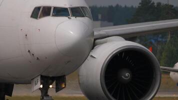 MOSCOW, RUSSIAN FEDERATION - JULY 29, 2021. Boeing 777, VP-BJF of Ikar Airlines airlines taxiing at Sheremetyevo airport. Close-up of the chassis and engine. Airplane on the airfield. Travel concept. video