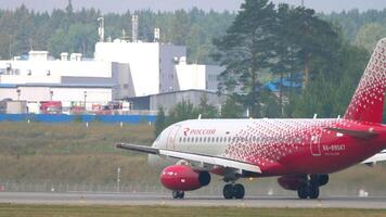 MOSCOW, RUSSIAN FEDERATION - JULY 29, 2021. Commercial plane Sukhoi Superjet 100, RA-89047 of Rossiya taxiing, side view. Travel concept video