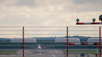 Plane landing, touching runway and braking, long shot. Jet airplane approaching. Aircraft arriving. Airfield and runway. Air industry, travel and tourism concept video