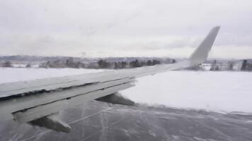 Airplane takeoff on a winter day. The porthole is covered with anti-icing mixture video