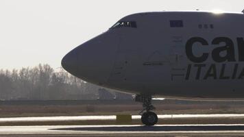 NOVOSIBIRSK, RUSSIAN FEDERATION - OCTOBER 20, 2021. Cargo jumbo jet Boeing 747, LX-TCV of Cargolux taxiing at Tolmachevo airport, middle shot, side view video