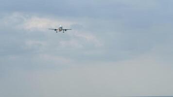 Passenger plane landing, long shot, front view. Jet plane approaching. Travel concept video