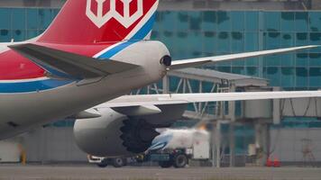 NOVOSIBIRSK, RUSSIAN FEDERATION - JUNE 10, 2020. Airplane tail close-up. Jumbo jet Cargolux at Tolmachevo airport. Aircraft part against terminal background. Rudder. Trim tabs video