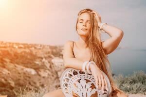 Happy boho woman portrait. Boho chic fashion style. Outdoor photo of free happy woman with long hair, sunny weather outdoors with sea mountains nature beautiful background.