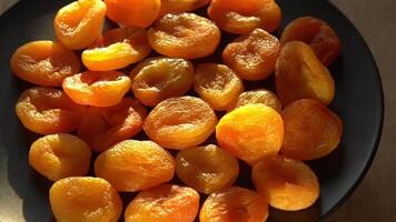 Dried apricots close-up. Apricot fruit food. Top view bowl. video