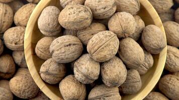 Walnut in shell. Background view from above. Healthy food bowl top view. video