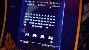 Space invaders Taito game machine. Simple Space Arcade in 8-bit retro video old game. Warsaw, Poland - July 28, 2023.