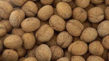 Walnut in shell. Background view from above. Healthy food top view. video