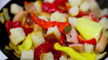 vegetable ragout with pieces of white bread frying on a frying pan with steam, closeup video