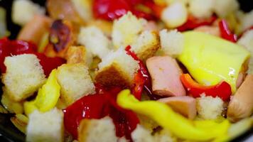 vegetable ragout with pieces of white bread frying on a frying pan with steam, closeup video