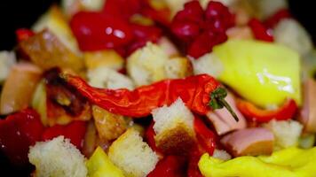 vegetable ragout with pieces of white bread frying on a frying pan with steam, closeup video