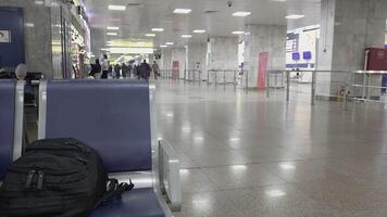 black backpack on chair in Manas airport video