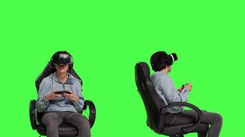 Woman gamer losing and winning at mobile video games against greenscreen backdrop, playing with virtual reality headset. Girl feeling cheerful and disappointed with win and failure. Camera B.