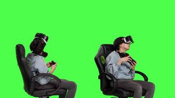 Happy gamer winning video games tournament with vr glasses, playing mobile gaming championship using her smartphone and virtual reality interactive headset. Greenscreen backdrop. Camera B.