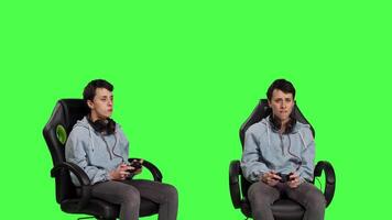 Gamer feeling angry about losing video games competition against greenscreen, playing on console with controller and gaming setup. Irritated displeased woman lost shooter action. Camera B.