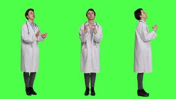 Angry physician yelling at people and being aggressive in studio, getting mad and furious at something against greenscreen backdrop. Irritated annoyed medic screaming, being displeased. Camera A. video