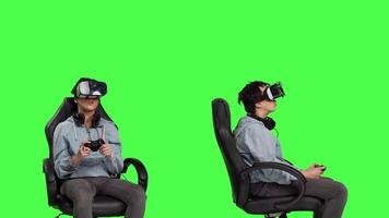 Player using virtual reality glasses to have fun on cyberspace gaming competition, playing video games and winning. Gamer against greenscreen backdrop uses vr headset and controller. Camera B.