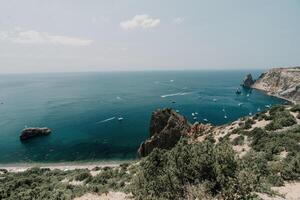 Sea lagoon. Panoramic view on calm azure sea and volcanic rocky photo