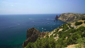 aereo panoramico Visualizza di paesaggio marino con cristallo chiaro azzurro mare e roccioso sponde. yachts nel un' bellissimo laguna su fondale di rocce. il concetto di un ideale destinazione per estate viaggio e vacanza. video