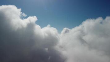 Aerial view. The drone flies over foggy and fluffy clouds. Blue sky sun and sea fog. Abstract aerial nature summer ocean sunset sea and sky background. Vacation, vacation and holiday concept video