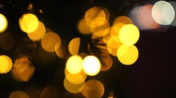 Abstract festive yellow-orange lights with bokeh, sparkling circular stars motion. Holiday concept backdrop. Holiday concept backdrop with twinkling bright shapes. Blinking Christmas Tree lights video