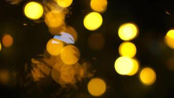 Abstract festive yellow-orange lights with bokeh, sparkling circular stars motion. Holiday concept backdrop. Holiday concept backdrop with twinkling bright shapes. Blinking Christmas Tree lights video