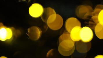 Abstract festive yellow-orange lights with bokeh, sparkling circular stars motion. Holiday concept backdrop. Holiday concept backdrop with twinkling bright shapes. Blinking Christmas Tree lights video