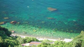 Aerial view on calm azure sea and volcanic rocky shores. Small waves on water surface. Nature summer ocean sea beach view. Nobody. Holiday, vacation and travel concept. Weather and climate change video