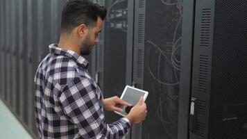 a man is standing in front of a server rack video