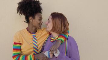 two women kissing on orange background video