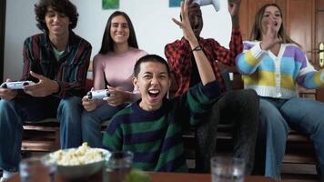 a group of people sitting on a couch with a game controller video