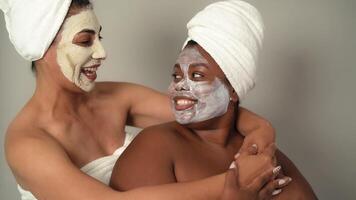 two women with facial masks on their faces video