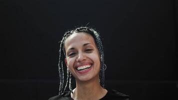 a woman with braids smiling at the camera video