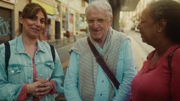 two women talking to an older man on a street video