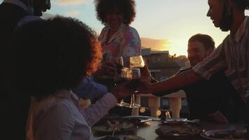 a group of people toasting wine on a rooftop video