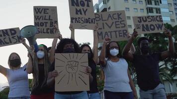 a group of people holding signs and wearing masks video