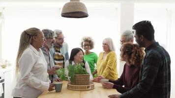 a group of people standing around a table in a kitchen video