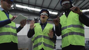 four people wearing safety vests vr glass and holding tablets video