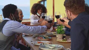 a group of people toasting with wine at a restaurant video