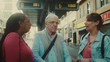 three people talking to each other on a street video