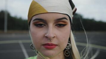 a woman with a headband and piercings on her face video