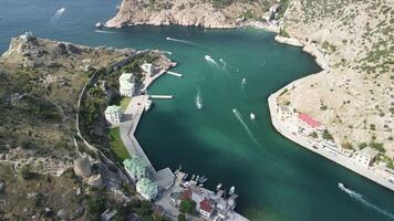 aéreo panorámico ver de Balaklava paisaje con barcos y mar en centro de deportes acuáticos bahía. Crimea sebastopol turista atracción. zumbido parte superior ver Disparo de Puerto para lujo yates, barcos y veleros video