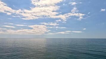 Sea water surface. Aerial view on calm water surface, camera flies over clear sea ocean. Sun glare. Abstract nautical summer ocean nature. Holiday and travel. Weather and climate change. Slow motion video