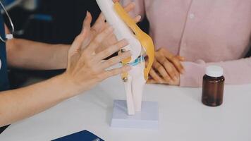 Human cruciate ligament injury treatment concept. Orthopedist showing to cruciate ligament in a knee-joint medical teaching model, close-up video