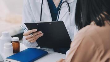 Doctor and patient discussing something while sitting at the table . Medicine and health care concept. Doctor and patient video