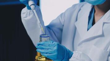 Young scientists conducting research investigations in a medical laboratory, a researcher in the foreground is using a microscope video