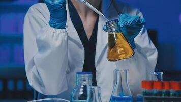 Young scientists conducting research investigations in a medical laboratory, a researcher in the foreground is using a microscope video