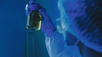 Young scientists conducting research investigations in a medical laboratory, a researcher in the foreground is using a microscope video